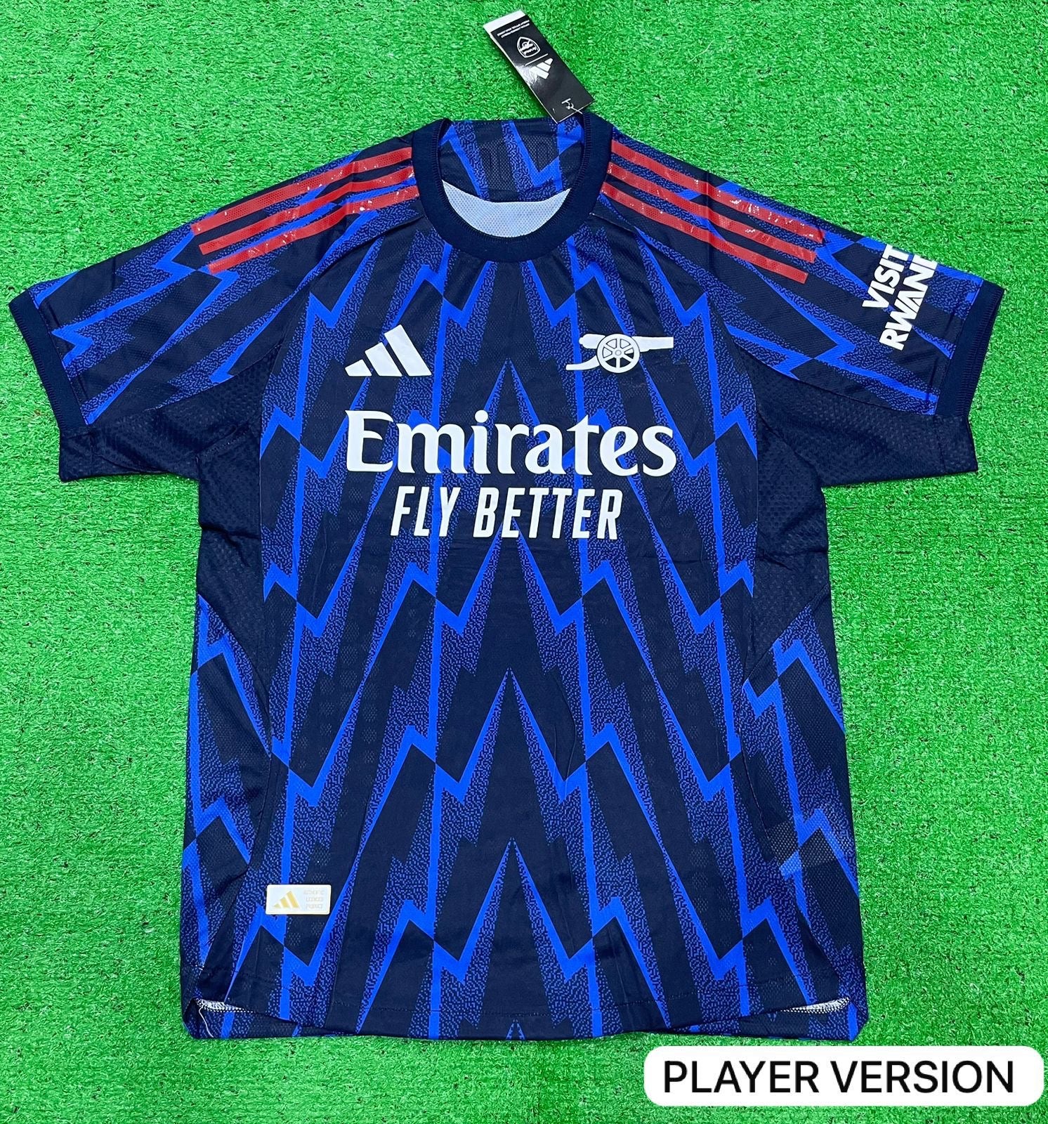 Adidas Arsenal 2025/26 away jersey in the night indigo/grey two colorway, featuring a lightning bolt graphic print.